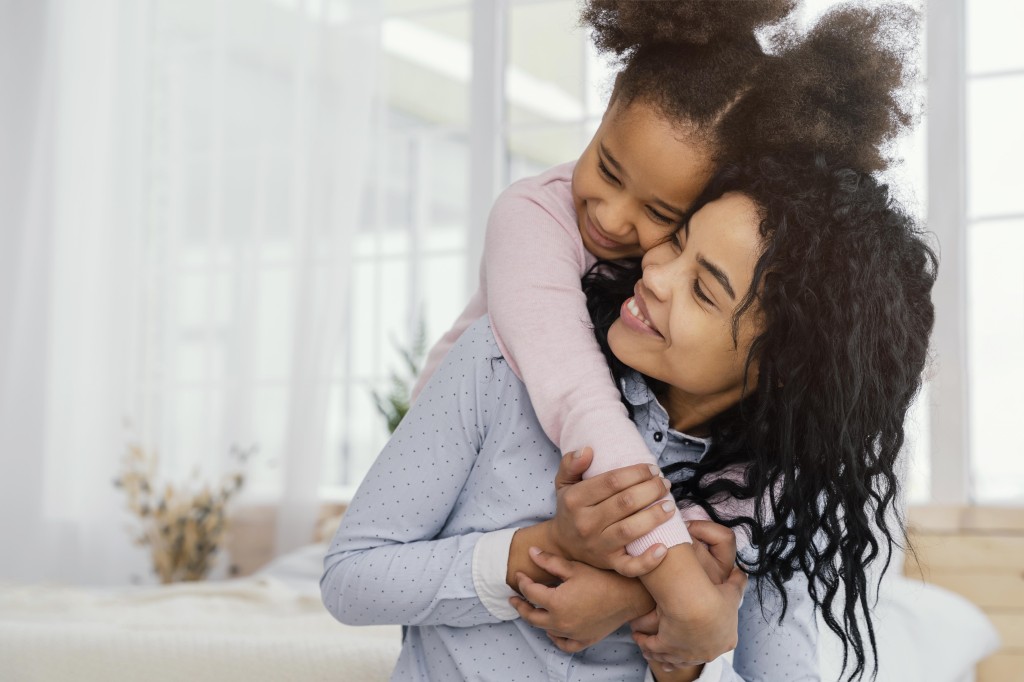 front-view-of-happy-mother-playing-at-home-with-her-daughter