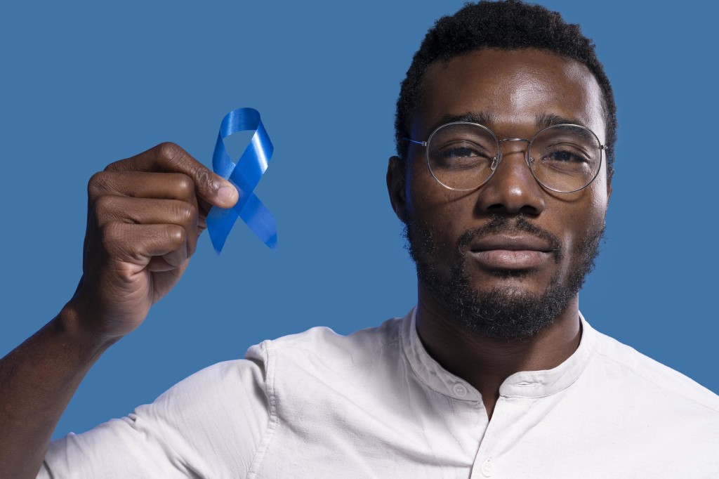 african-american-man-holding-a-blue-ribbon